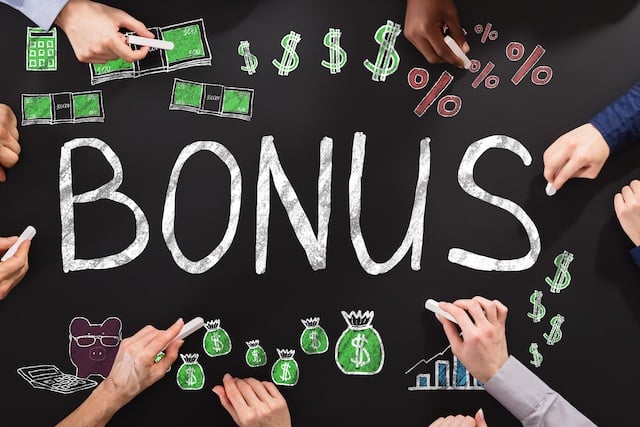 Hands Drawing Bonus And Employee Compensation Concept